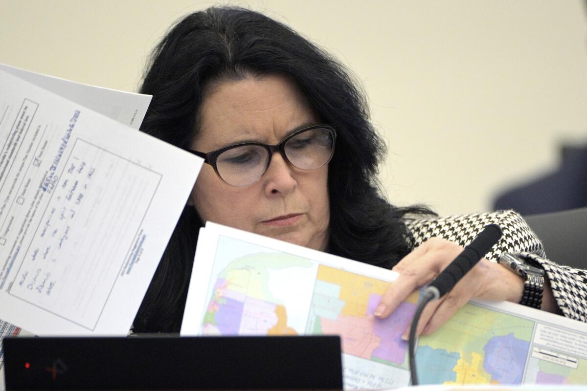 A state senator looks through redistricting maps.