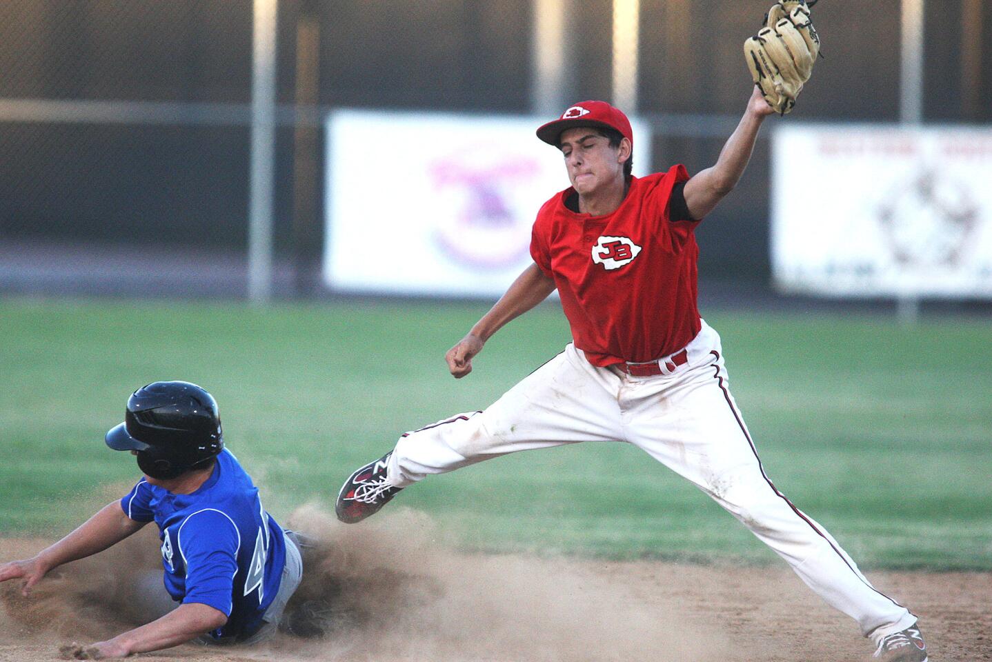 Burroughs' Ryan Galen stretches to catch the ball at second base on the steal by Burbank's Ryan Porras in a VIBL baseball playoff game at Burroughs High School in Burbank on Thursday, July 17, 2014. (Tim Berger/Staff Photographer)