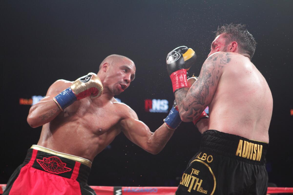 Andre Ward, left, lands an uppercut on Paul Smith on Saturday night in Oakland.