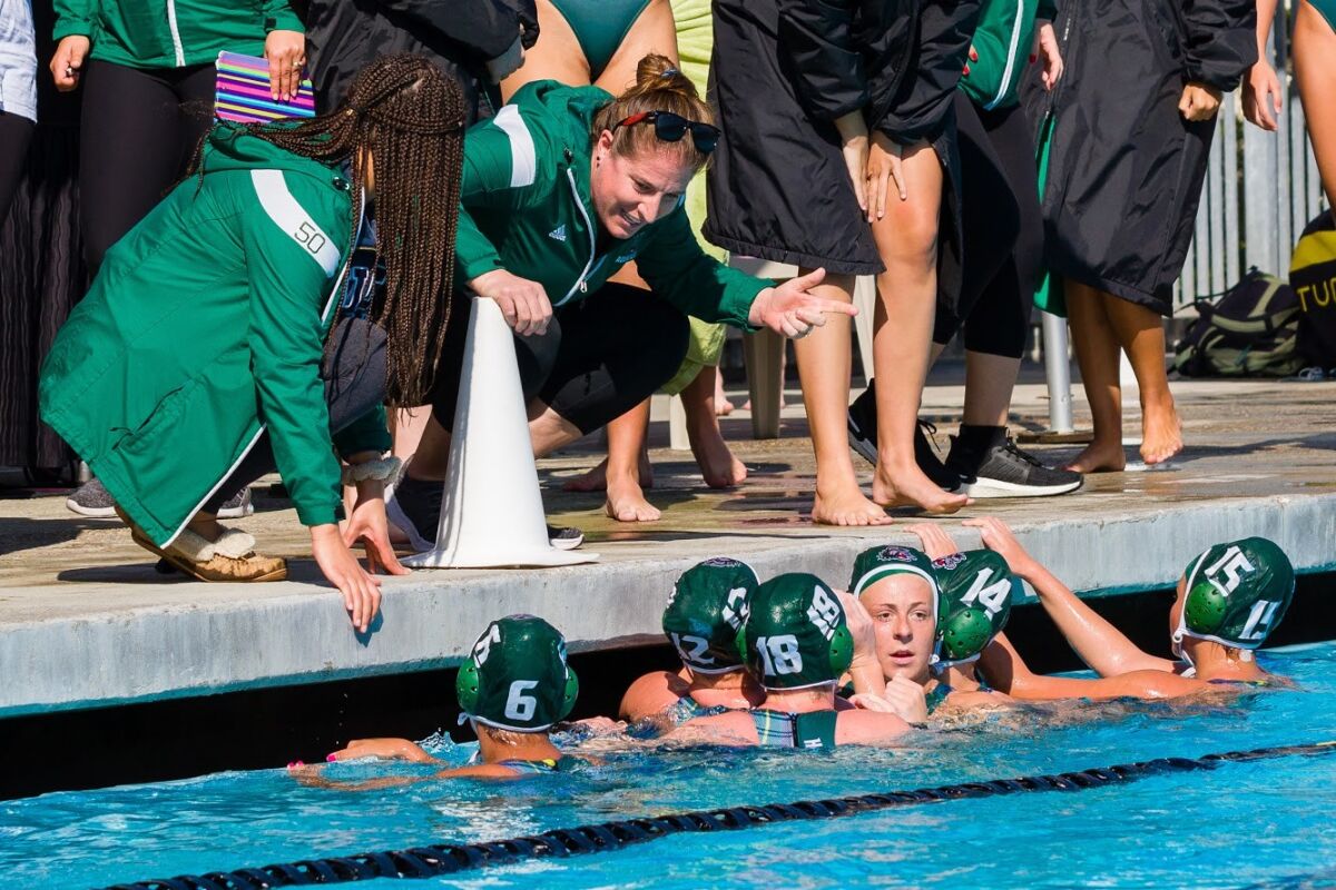 Helix girls water polo coach Lenelle Wylie addresses the team during a playoff game against Poway in February at La Jolla High's Coggan Family Aquatic Center.