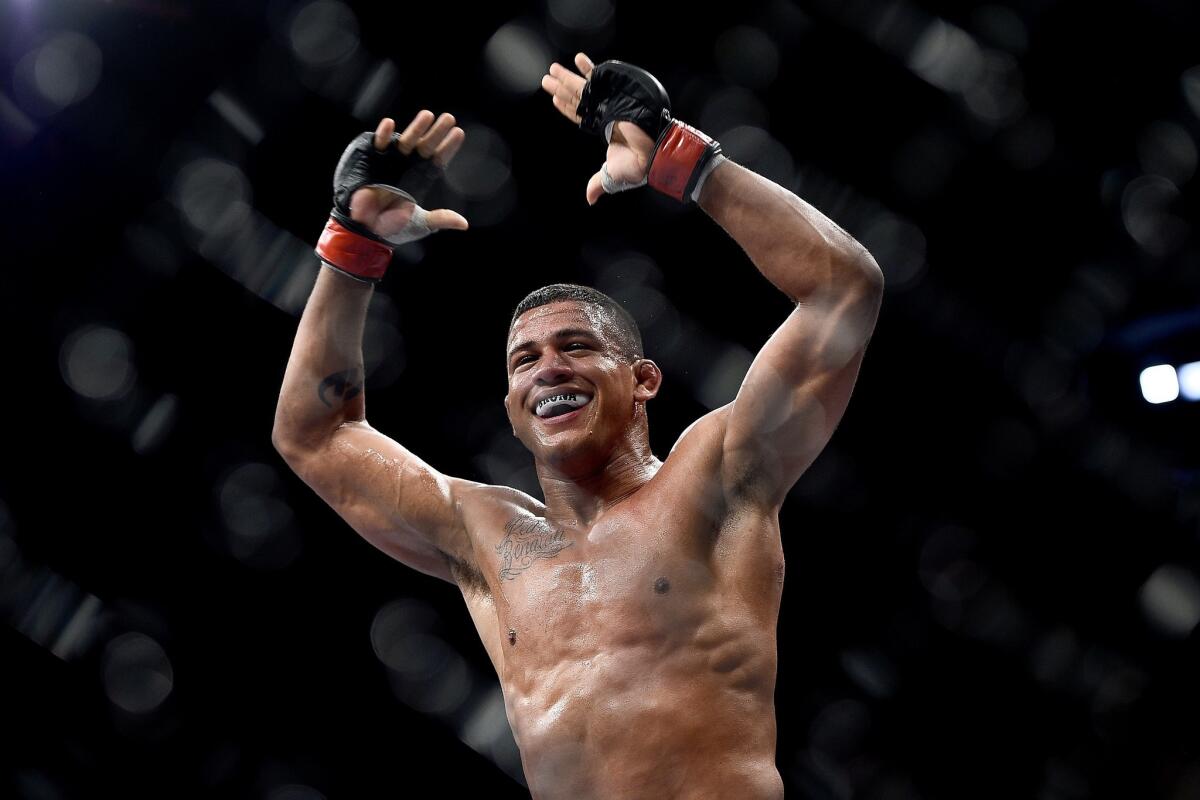 Gilbert Burns celebrates after his submission victory over Christos Giagos at UFC 179 in 2014.