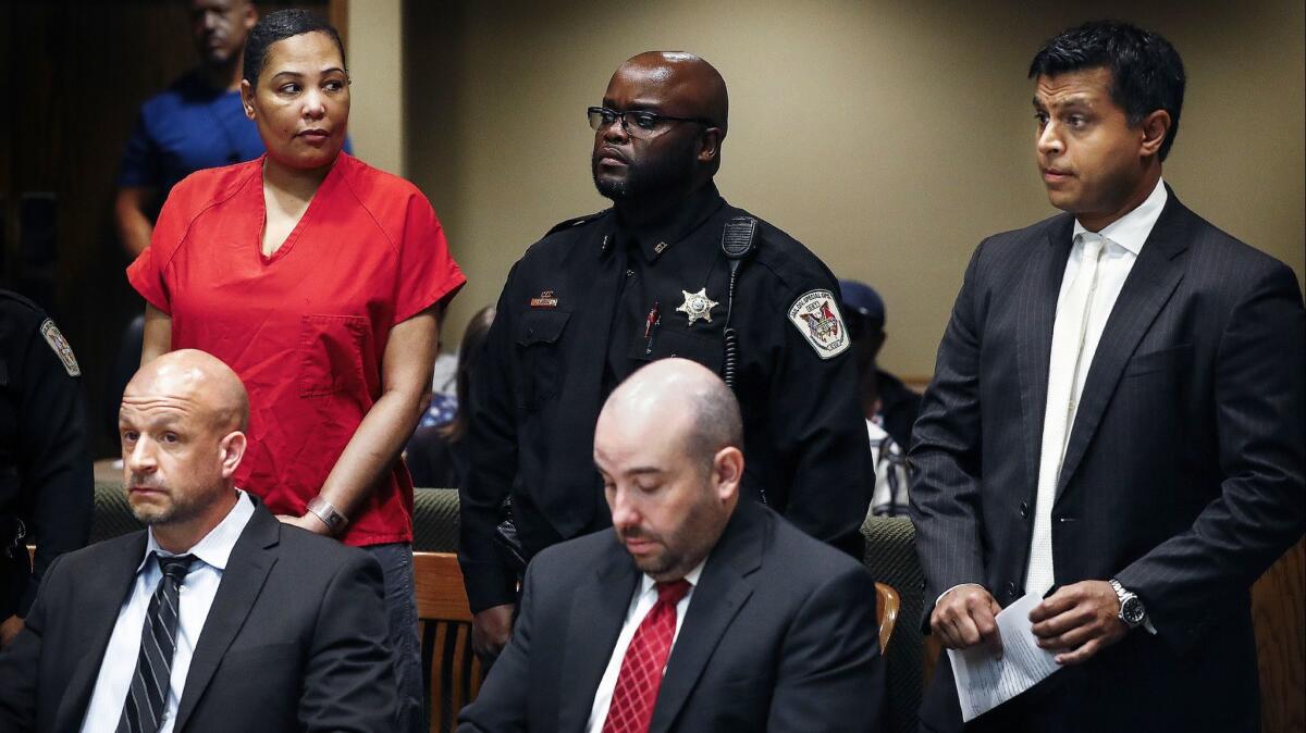 Sherra Wright, left, glances at attorney Juni Ganguli, right, after her lawyers Steve Farese and Blake Ballin asked to be withdrawn from representing her in Shelby County Criminal Court in Memphis on July 11, 2018.