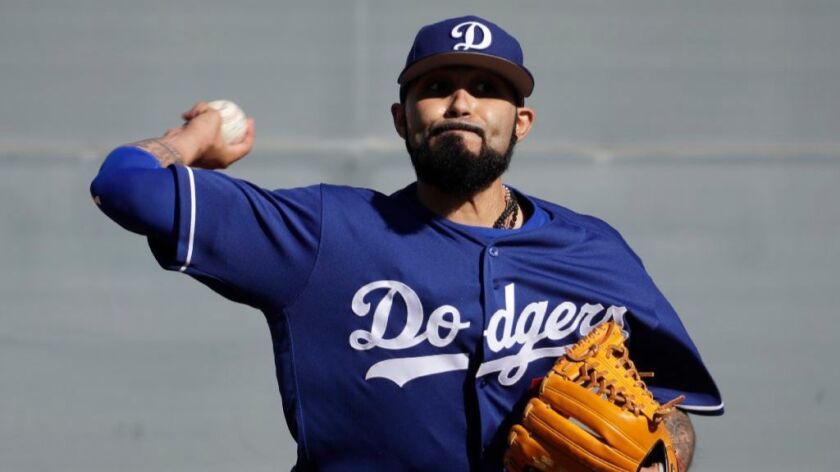 Dodgers reliever Sergio Romo throws during a spring training baseball workout on Feb. 14 in Glendale, Ariz.