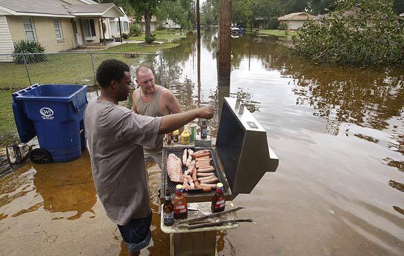 Floodwaters in Slidell, La., can't stop neighbors Chuck Miller and Johnny Sontag from barbecuing. At the height of the hurricane, the water was chest-high, Sontag said.
