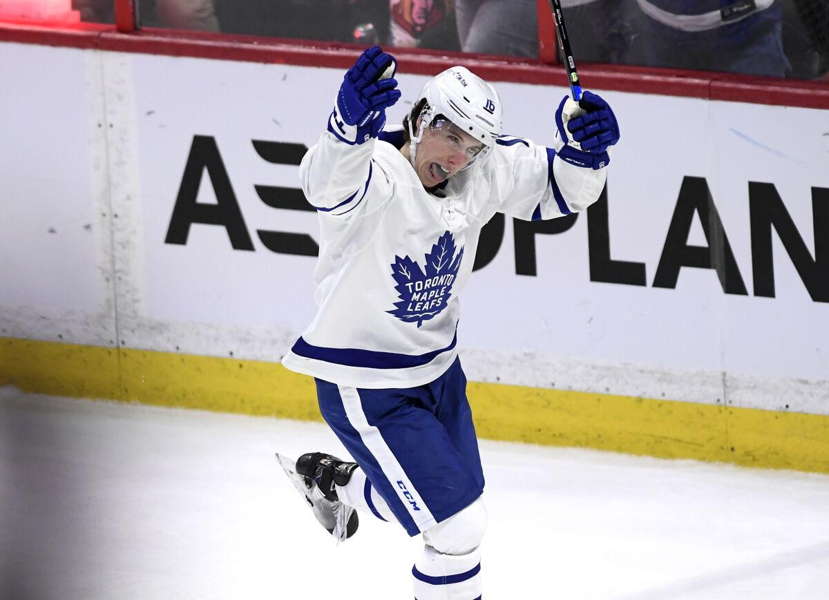 Toronto Maple Leafs right wing Mitchell Marner (16) celebrates his goal against the Ottawa Senators to tie an NHL gockey game during third-period action in Ottawa, Ontario, Saturday, April 16, 2022. (Justin Tang/The Canadian Press via AP)