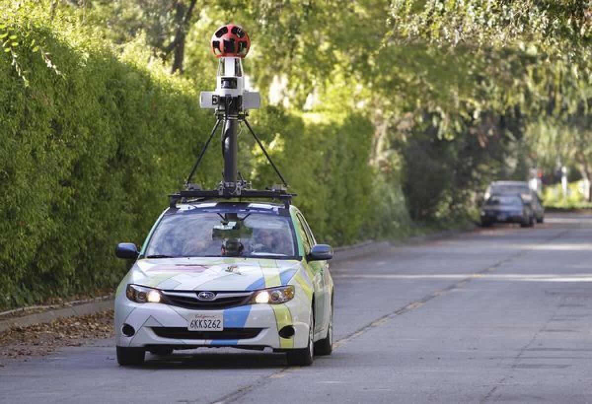A Google employee drives a Street View car around Palo Alto, Calif.