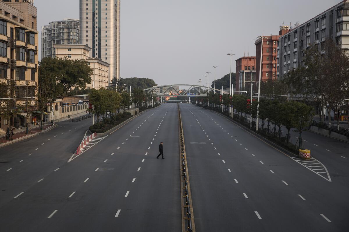 Un hombre cruza una carretera vacía el 3 de febrero en Wuhan, en la provincia china de Hubei.