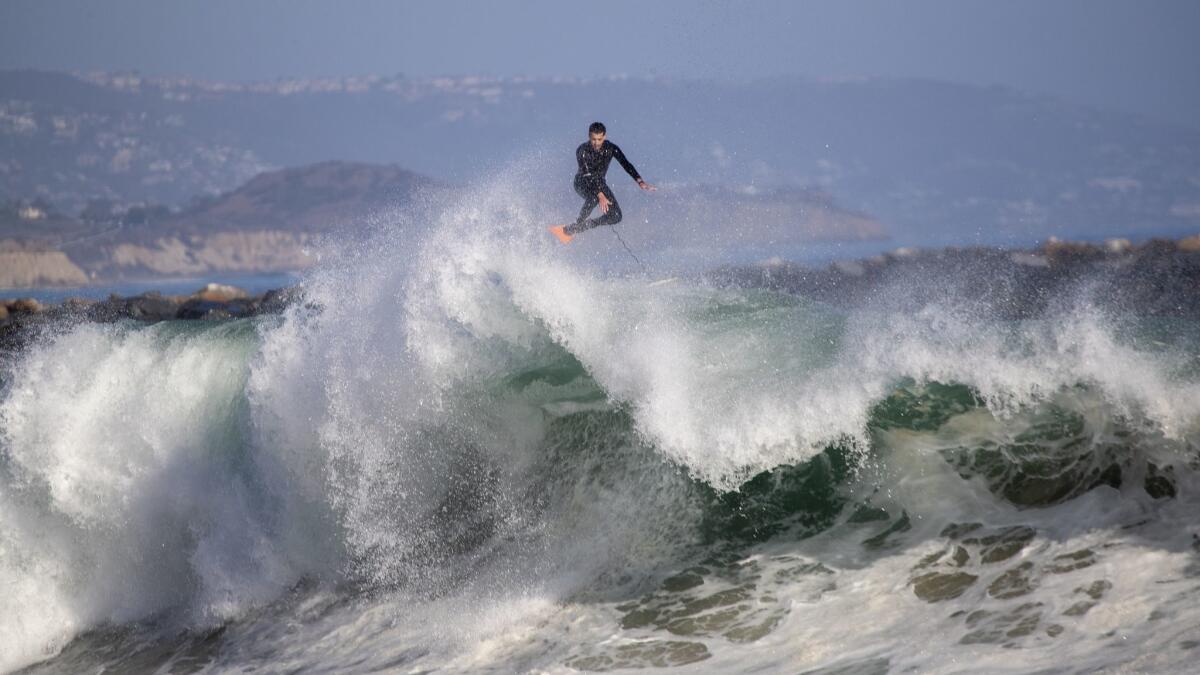 A body boarder soars without his board over a wave in Newport Beach on Monday. Large waves and strong rip currents continue through Tuesday at south-facing beaches.