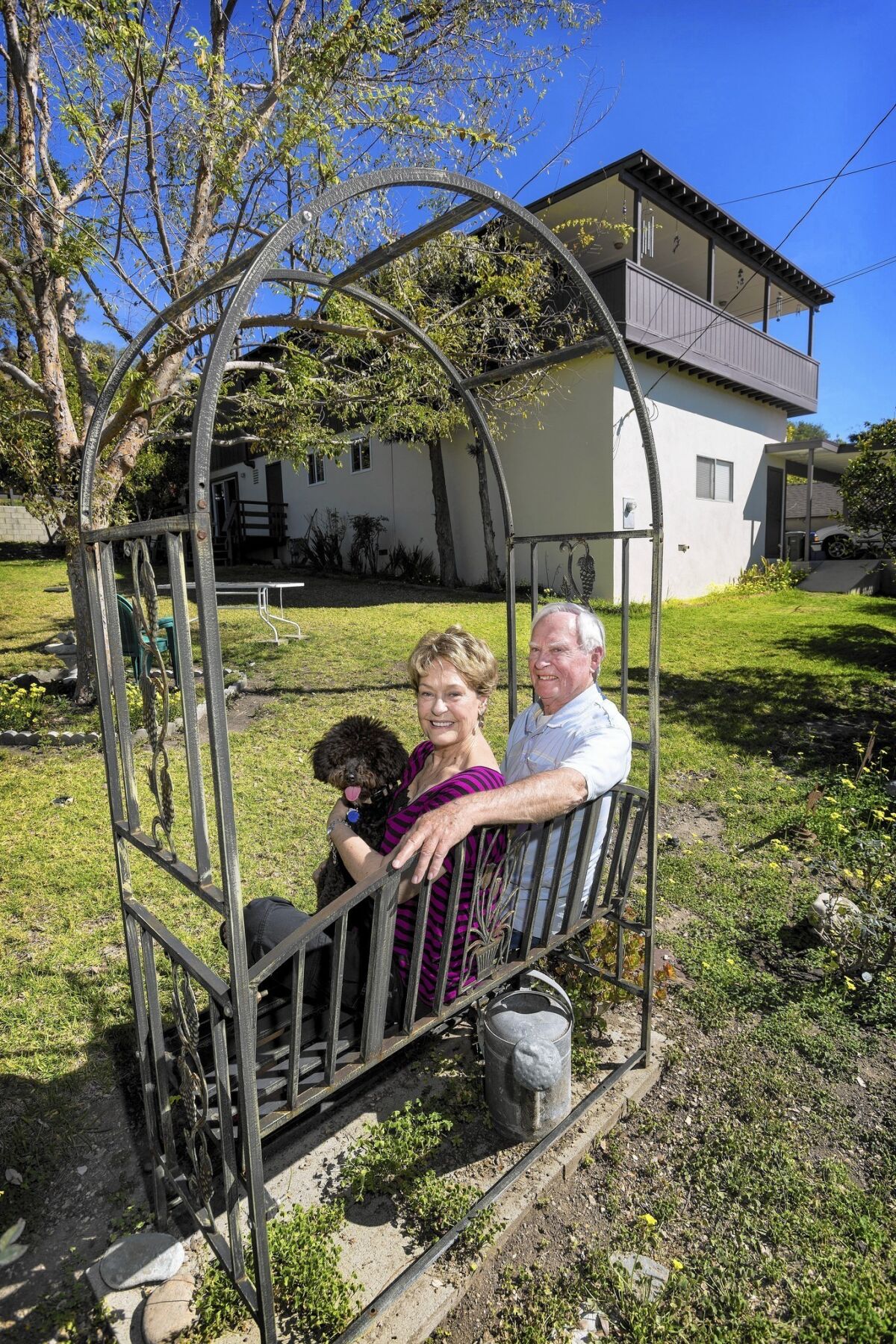 Retirees Wana and Owen Klasen, holding their dog Jager, at their home in Fillmore in Ventura County. They recently got a home equity line of credit that they used to paint and re-roof their house. They couldn't qualify for the credit line last year, but rising home prices made it possible this year.