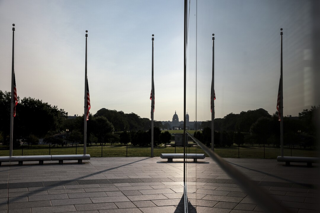 Flags encircling the Washington Monument are flown at half-staff