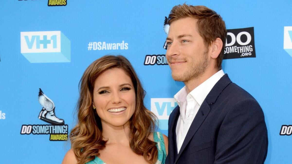 Dan Fredinburg, with then-girlfriend Sophia Bush, arrives at the Do Something Awards at the Avalon in Los Angeles in July 2013.
