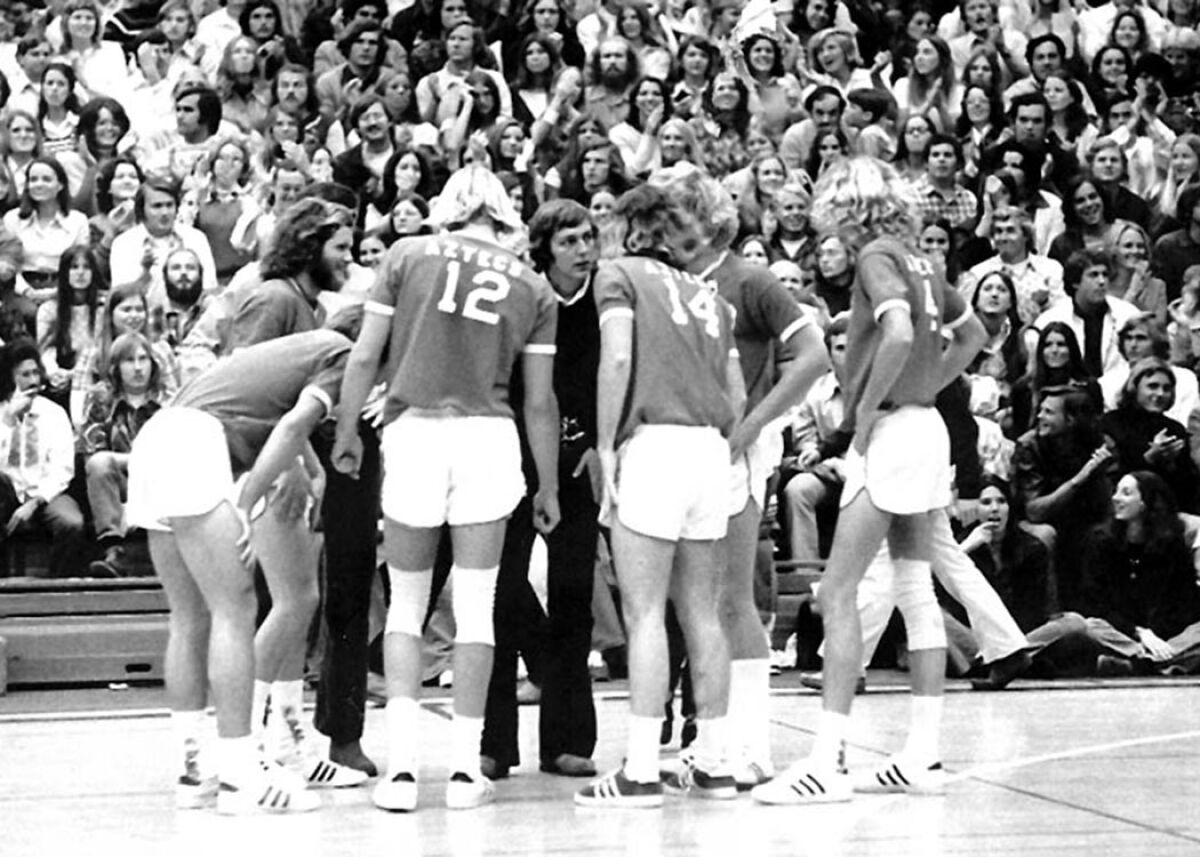 Coach Jack Henn talks it over with the Aztec players in a 1973 league match in Peterson Gym.
