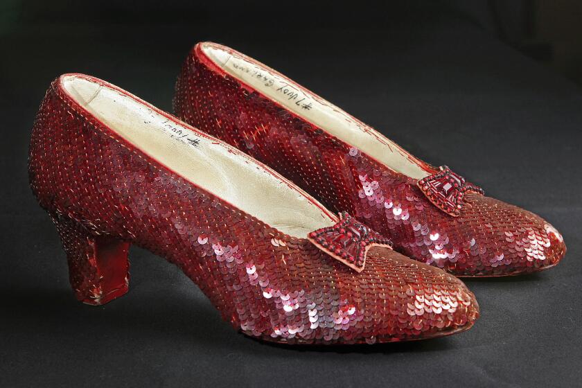 FILE - Sequin-covered ruby slippers worn by Judy Garland in "The Wizard of Oz" appear at the offices of Profiles in History in Calabasas, Calif. on Nov. 9, 2001. A dying thief who confessed to stealing the slippers because he wanted to pull off “one last score,” was given no prison time at his sentencing hearing Monday, Jan 29, 2024. The thief, Terry Jon Martin, said he had planned to remove what he thought were real rubies from the shoes and sell them. Once he learned the shoes were adorned only with sequins and glass beads, he got rid of them. (AP Photo/Reed Saxon, File)