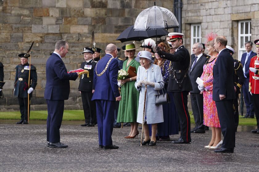 Britain's Queen Elizabeth II is greeted as she attends the Ceremony of the Keys on the forecourt of the Palace of Holyroodhouse in Edinburgh, Monday, June 27, 2022, as part of her traditional trip to Scotland for Holyrood week. (Jane Barlow/PA via AP)
