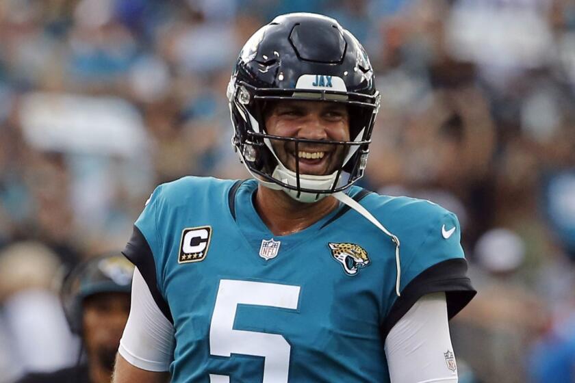 Jacksonville Jaguars quarterback Blake Bortles smiles at teammates during the first half of an NFL football game against the New England Patriots, Sunday, Sept. 16, 2018, in Jacksonville, Fla. (AP Photo/Stephen B. Morton)
