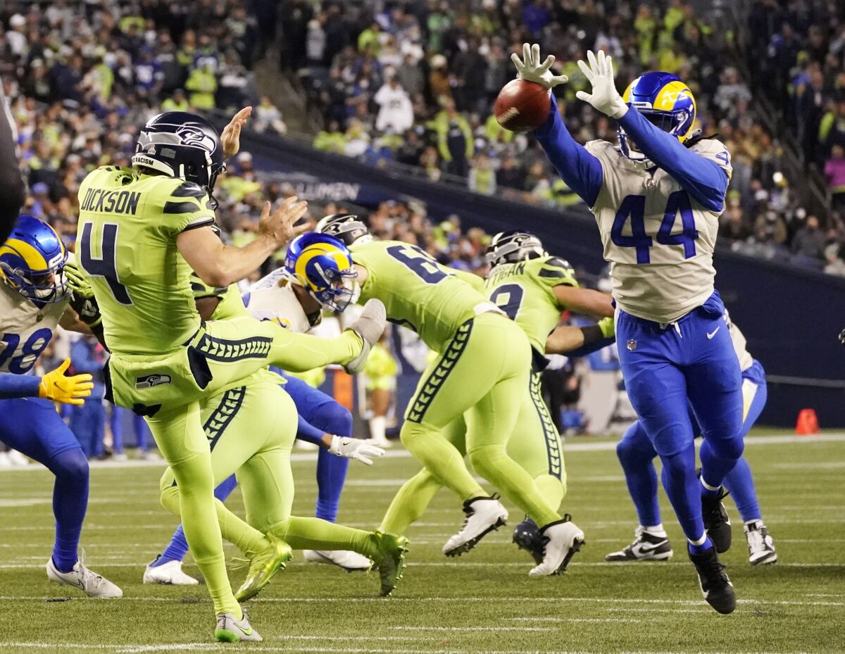 Los Angeles Rams linebacker Jamir Jones (44) blocks a kick by Seattle Seahawks punter Michael Dickson (4) during the second half of an NFL football game, Thursday, Oct. 7, 2021, in Seattle. (AP Photo/Elaine Thompson)