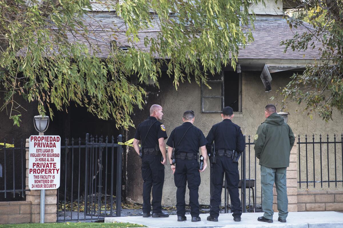 Law enforcement officials investigate the scene of suspected arson at the Islamic Society of the Coachella Valley on Friday.