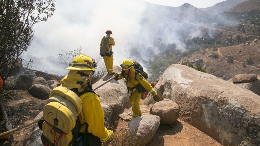 A Cal Fire crew fighting the San Pasqual fire on Friday faced shifting winds. By Saturday afternoon, fire officials said the fire had been 40 percent contained after scorching at least 360 acres.