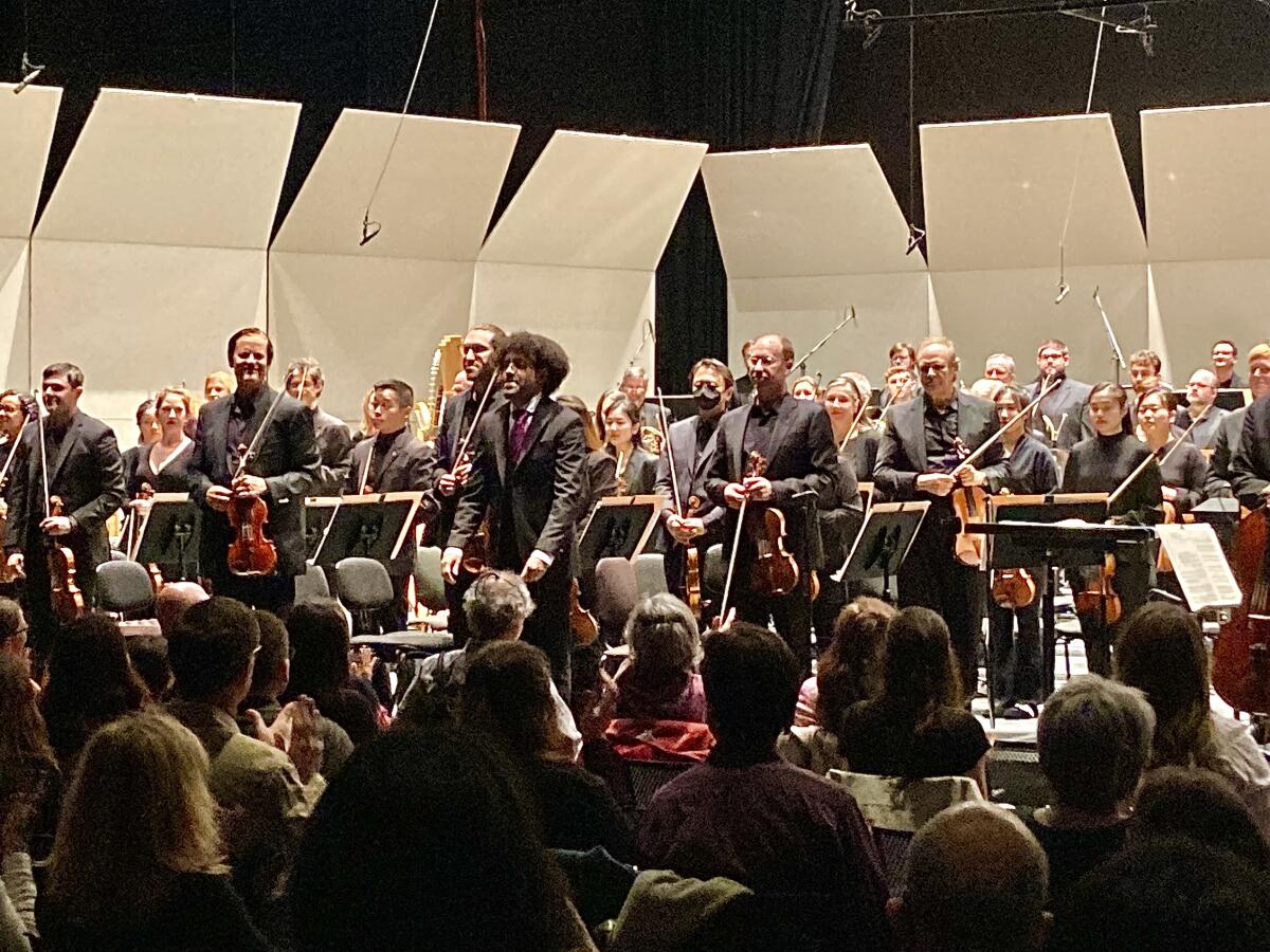 An orchestra takes its bows after a concert.