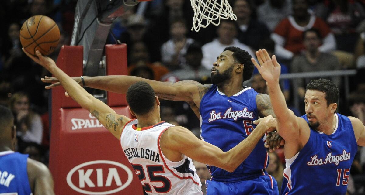 DeAndre Jordan goes for the block as Hawks guard Thabo Sefolosha shoots during the second half of the Clippers' 107-104 loss in Atlanta.