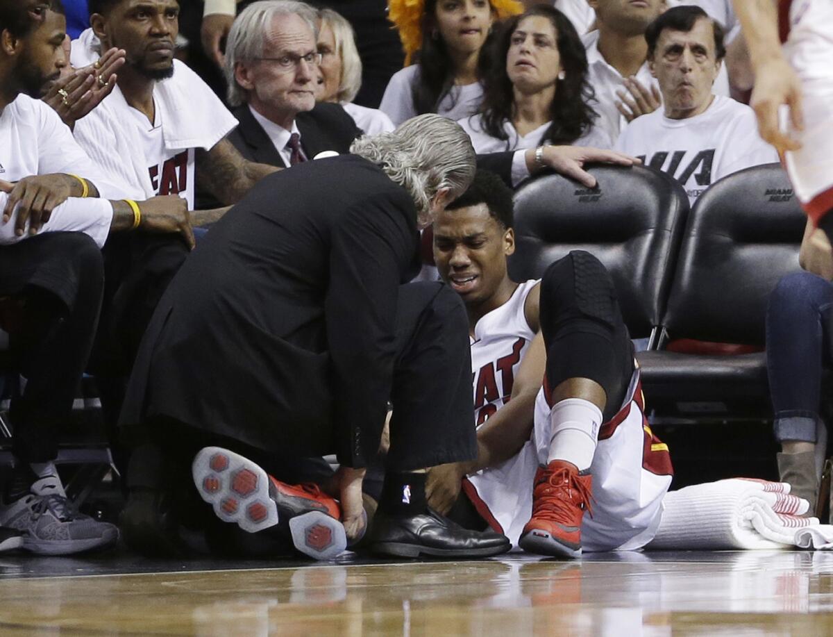 Heat center Hassan Whiteside (21) is attended by a team member after he was injured during the first half of Game 3 against the Raptors.