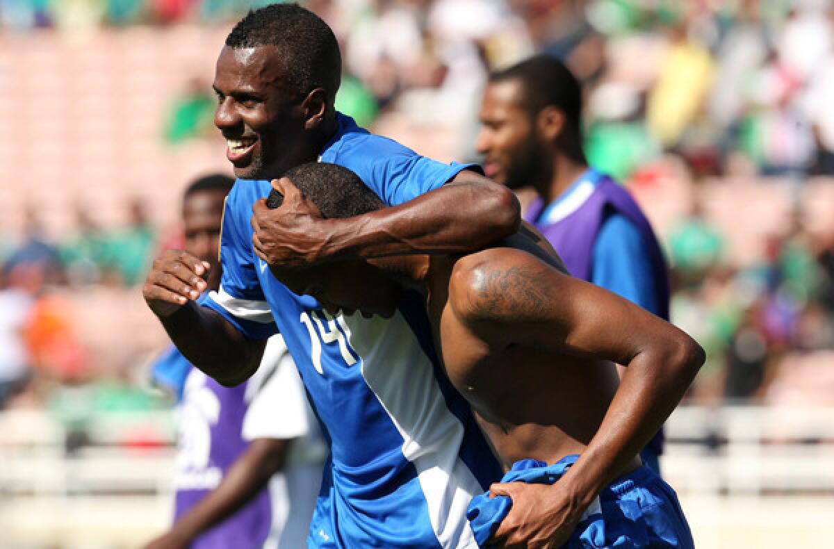 Martinique midfielder Fabrice Reuperne (14) celebrates with a teammate after defeating Canada, 1-0, on Sunday in Pasadena.