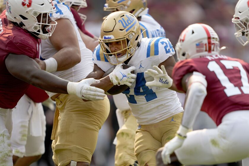 UCLA running back Zach Charbonnet (24) scores a touchdown past Stanford cornerback Kyu Blu Kelly (17) during the first half of an NCAA college football game Saturday, Sept. 25, 2021, in San Francisco, Calif. (AP Photo/Tony Avelar)