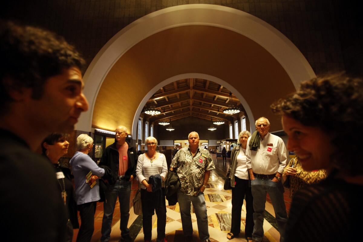 Special events at a May 3 celebration of Union Station's 75th anniversary will include architectural tours and live music. Pictured: In March, art docents Alex Amerri, left, and Emily Golan led an art tour of the station.