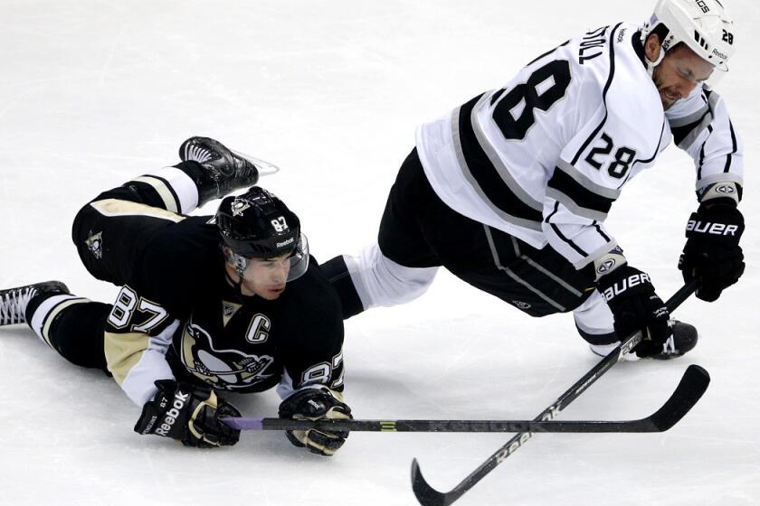 Kings center Jarret Stoll collides with Penguins center Sidney Crosby as they battle for possession of the puck.