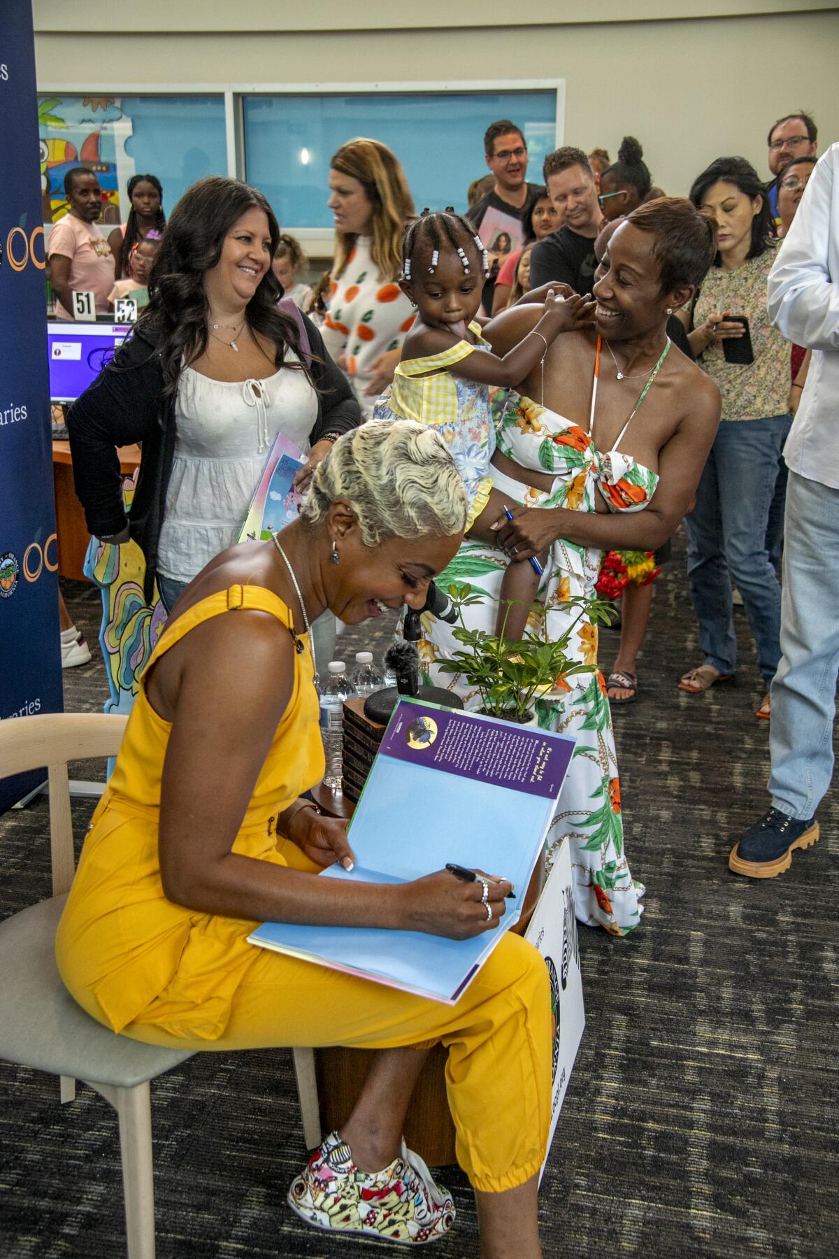Tiffany Haddish autographs her book for Aprilrae Turpin and her daughter, Tasha.