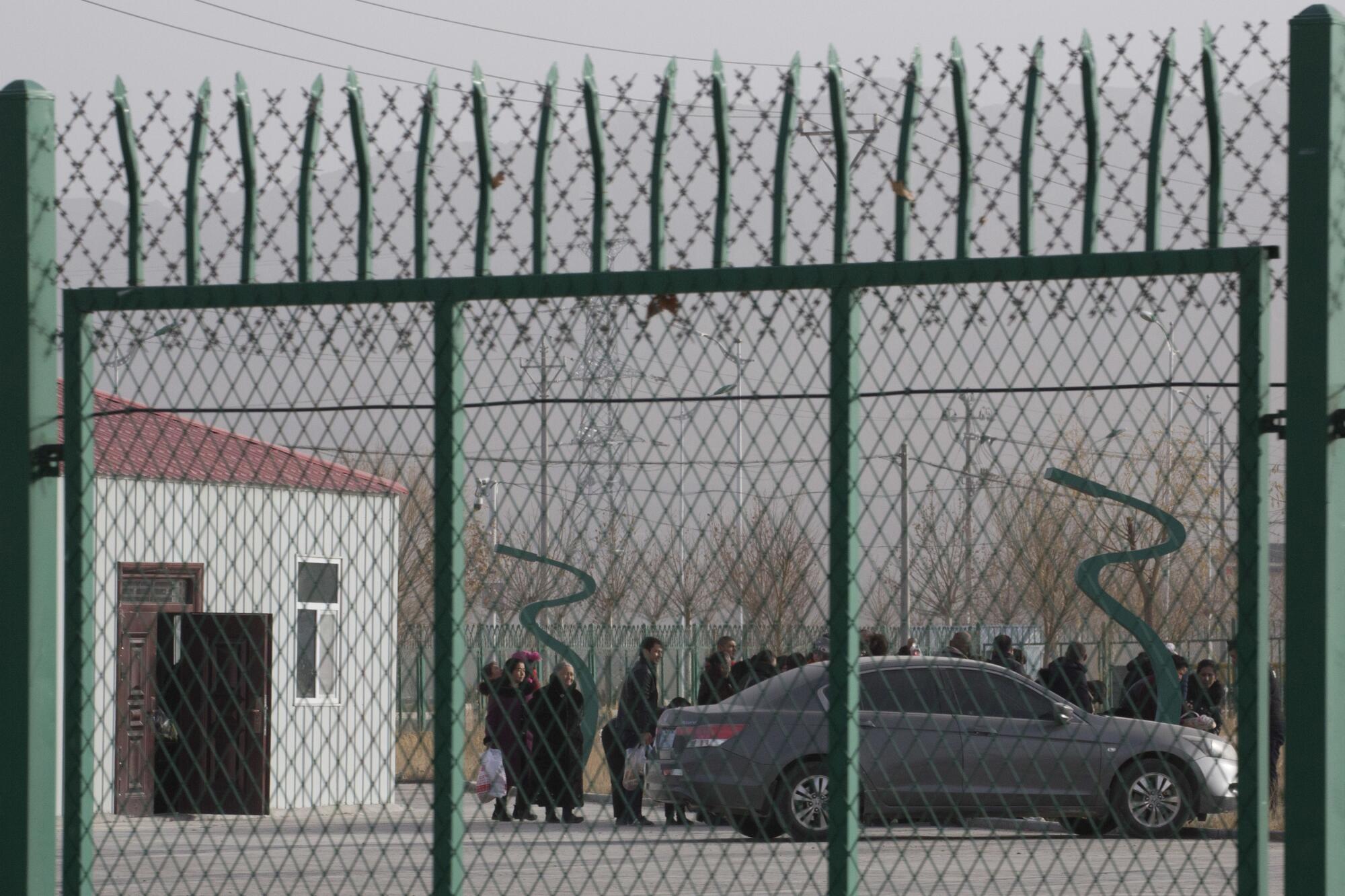 Residents line up at a site reported to be an indoctrination camp in Xinjiang, China. 
