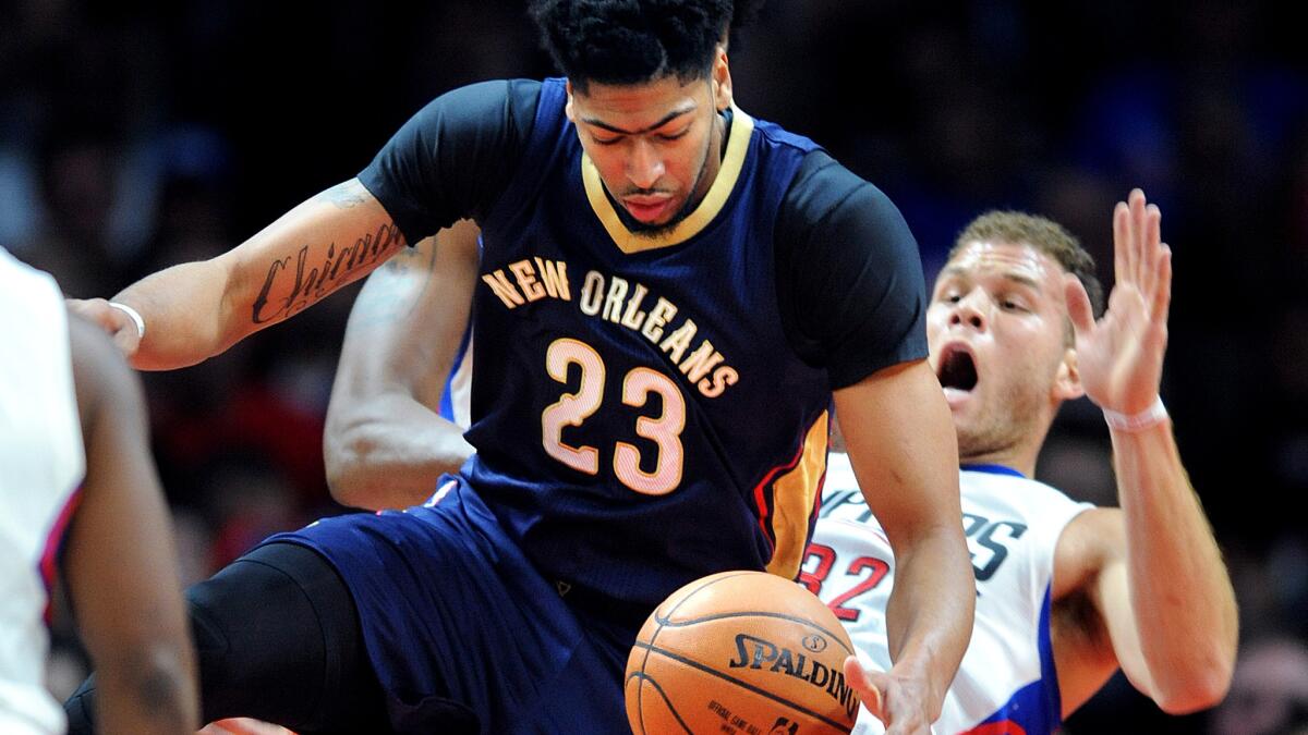 Clippers forward Blake Griffin falls to the court after Pelicans center Anthony Davis is called for a charging foul.