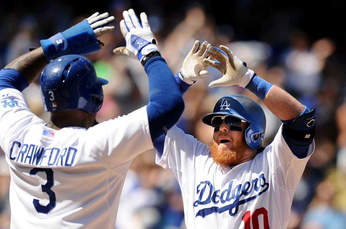 Justin Turner celebrates with Carl Crawford after hitting a two-run home run in September.
