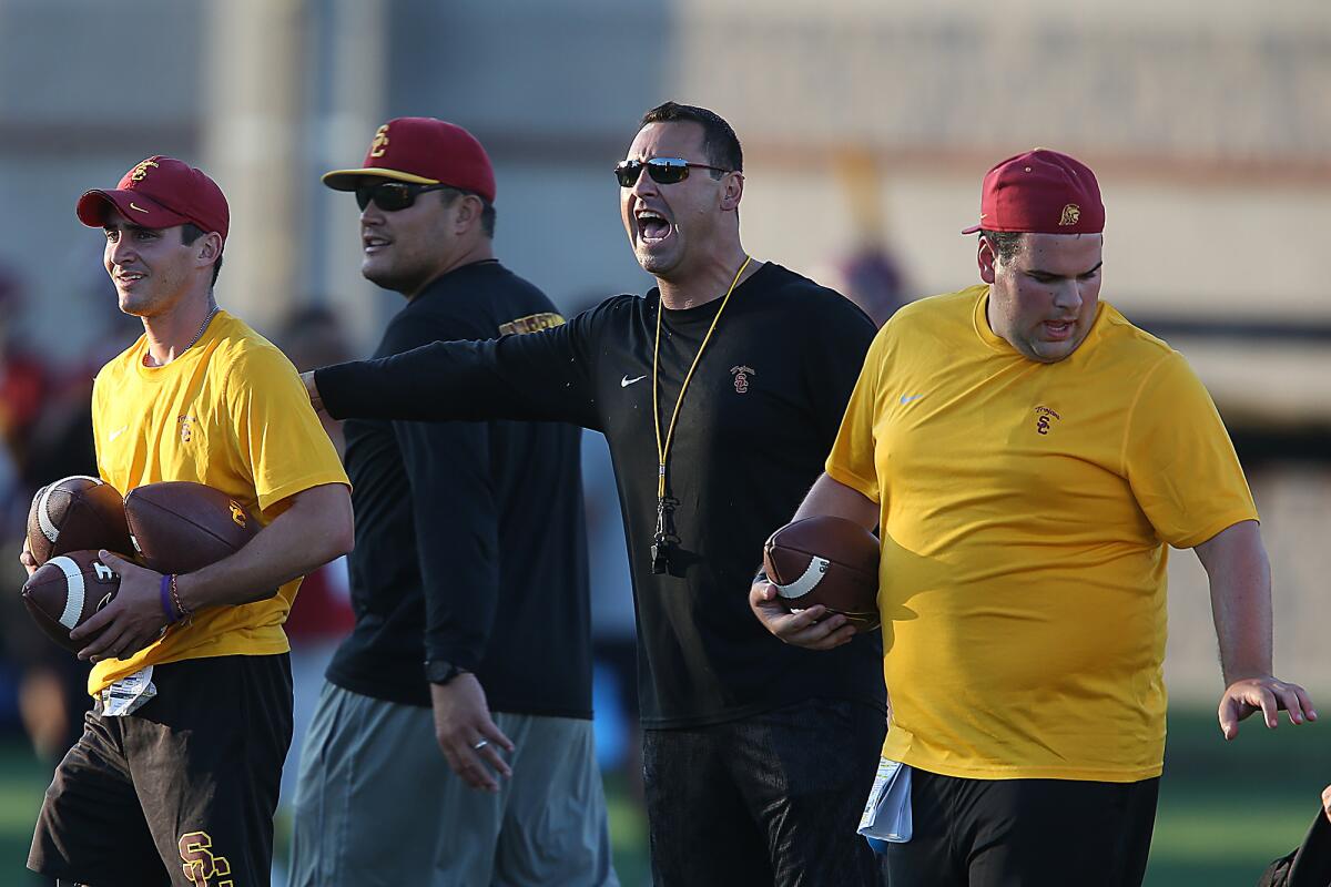USC Coach Steve Sarkisian yells out instructions to players during practice at Howard Jones Field on Aug. 8.