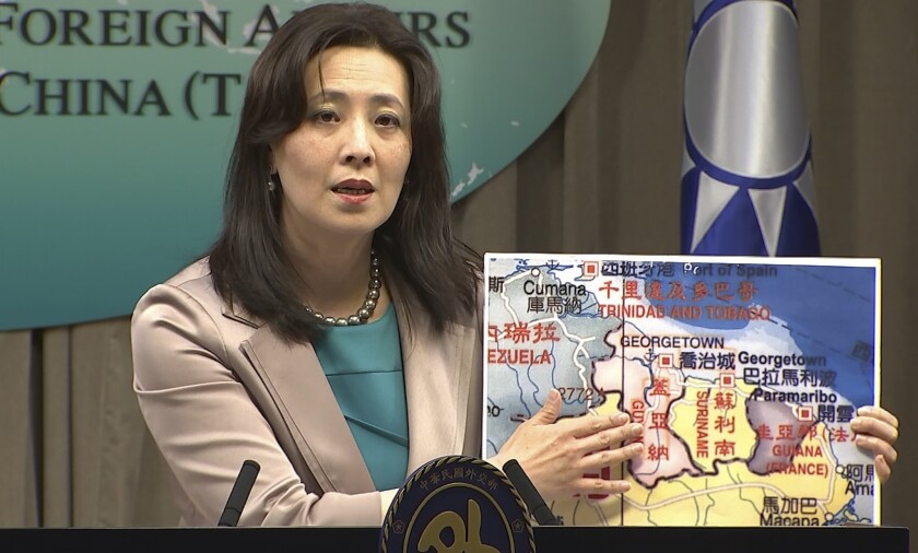 In this image made from video, Taiwan's Ministry of Foreign Affairs spokesperson Joanne Ou points at a map of Guyana at a weekly press conference, Thursday, Feb. 4, 2021, in Taipei, Taiwan. Taiwan has established a trade office in the South American country of Guyana, a diplomatic win for the island which has continued to lose allies in an aggressive poaching campaign from China in recent years. (AP Photo)