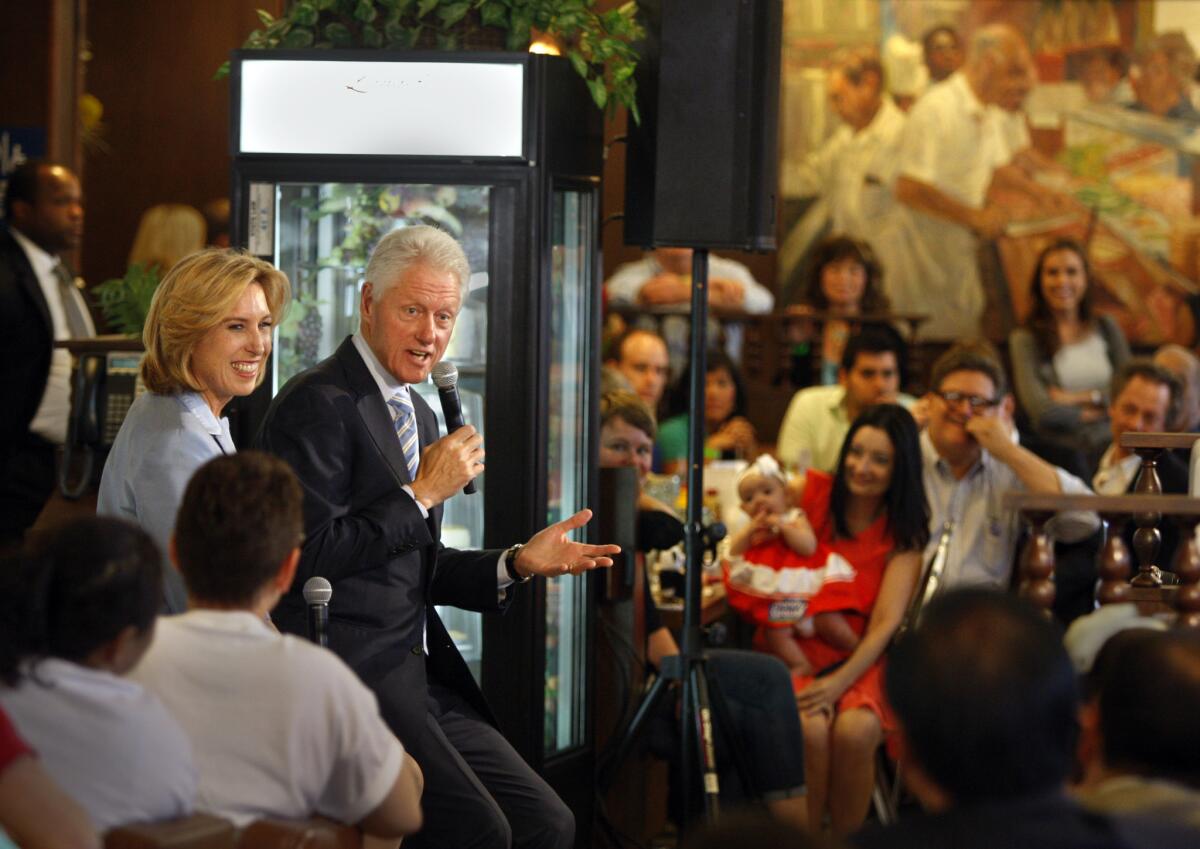 Former President Bill Clinton, center, appears in support of Los Angeles mayoral candidate Wendy Greuel, left, at Langer's Delicatessen on Saturday.