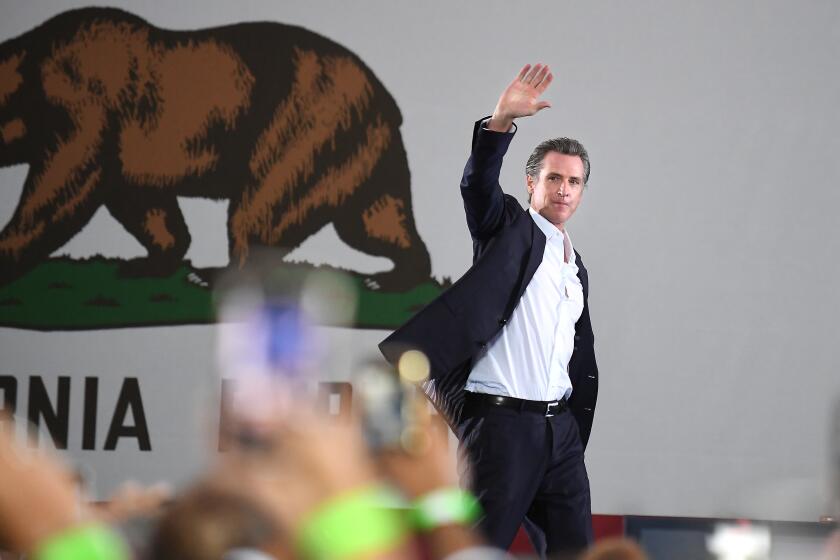 Long Beach, CA - September 13: California Governor Gavin Newsom waves to the crowd after appearing with U.S. President Joe Biden during a recall "no vote" campaign event for him at Long Beach City Collage, on Monday, Sept. 13, 2021 in Long Beach, CA. (Wally Skalij / Los Angeles Times)