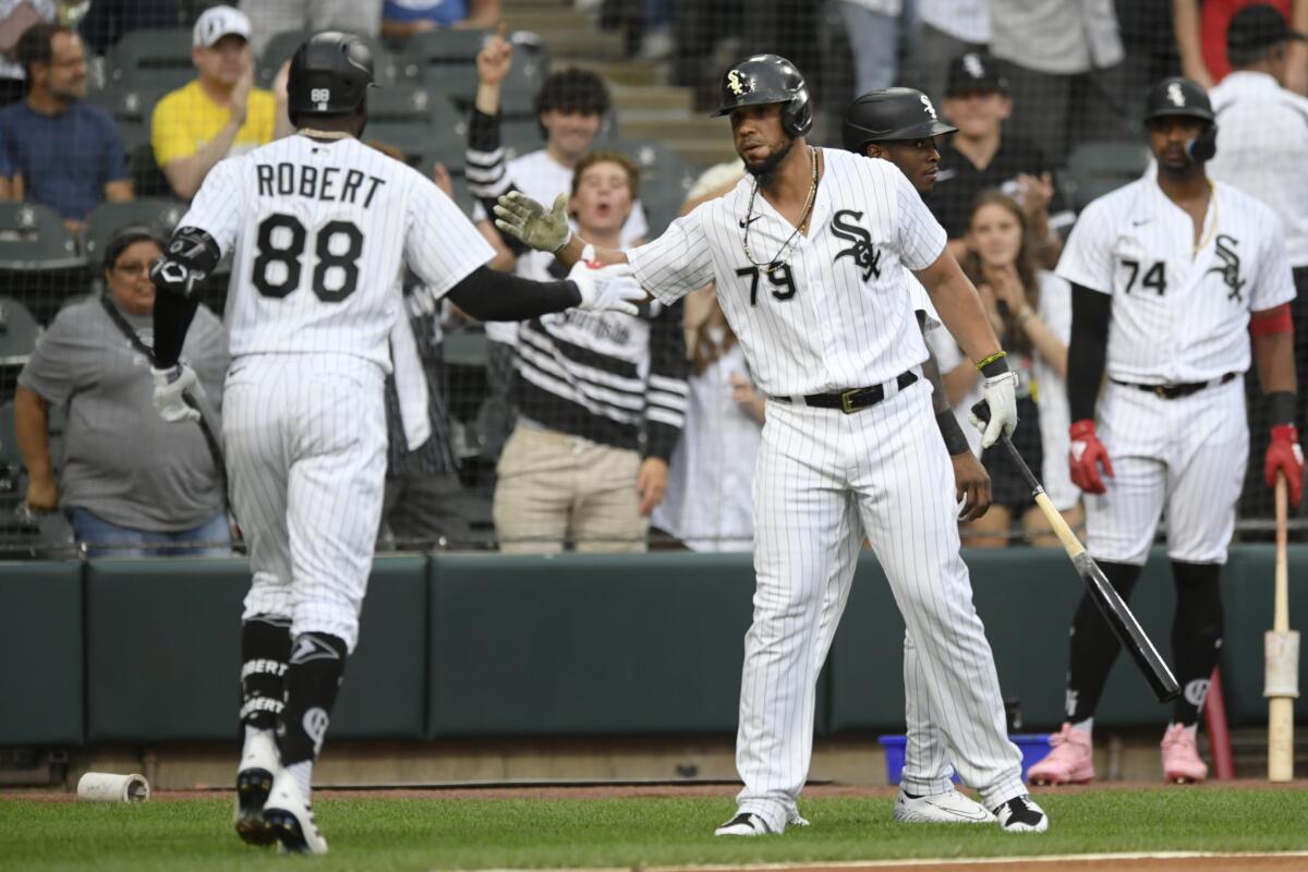Chicago White Sox's Luis Robert (88) celebrates with Jose Abreu (79) after hitting a two-run home run during the first inning of the team's baseball game against the Detroit Tigers on Friday, July 8, 2022, in Chicago. (AP Photo/Paul Beaty)