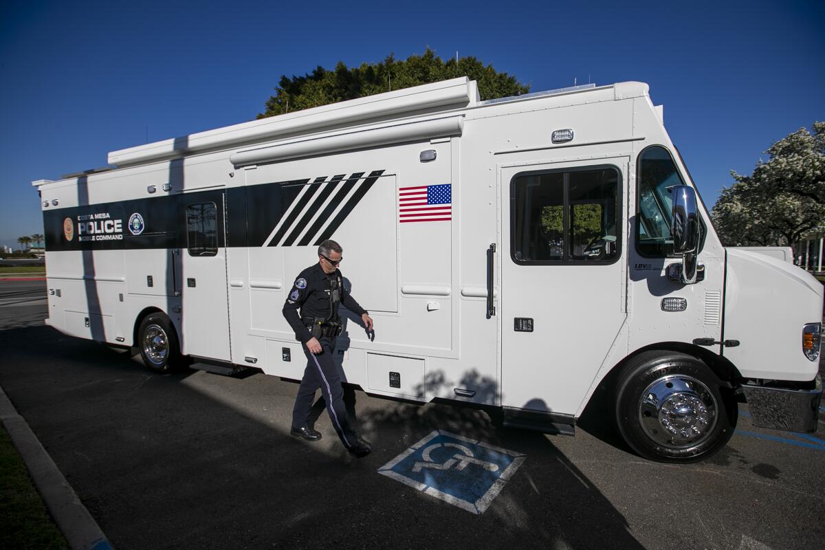 Sgt. Jared Barnes shows off the Costa Mesa Police Department's new mobile command vehicle on Thursday. 