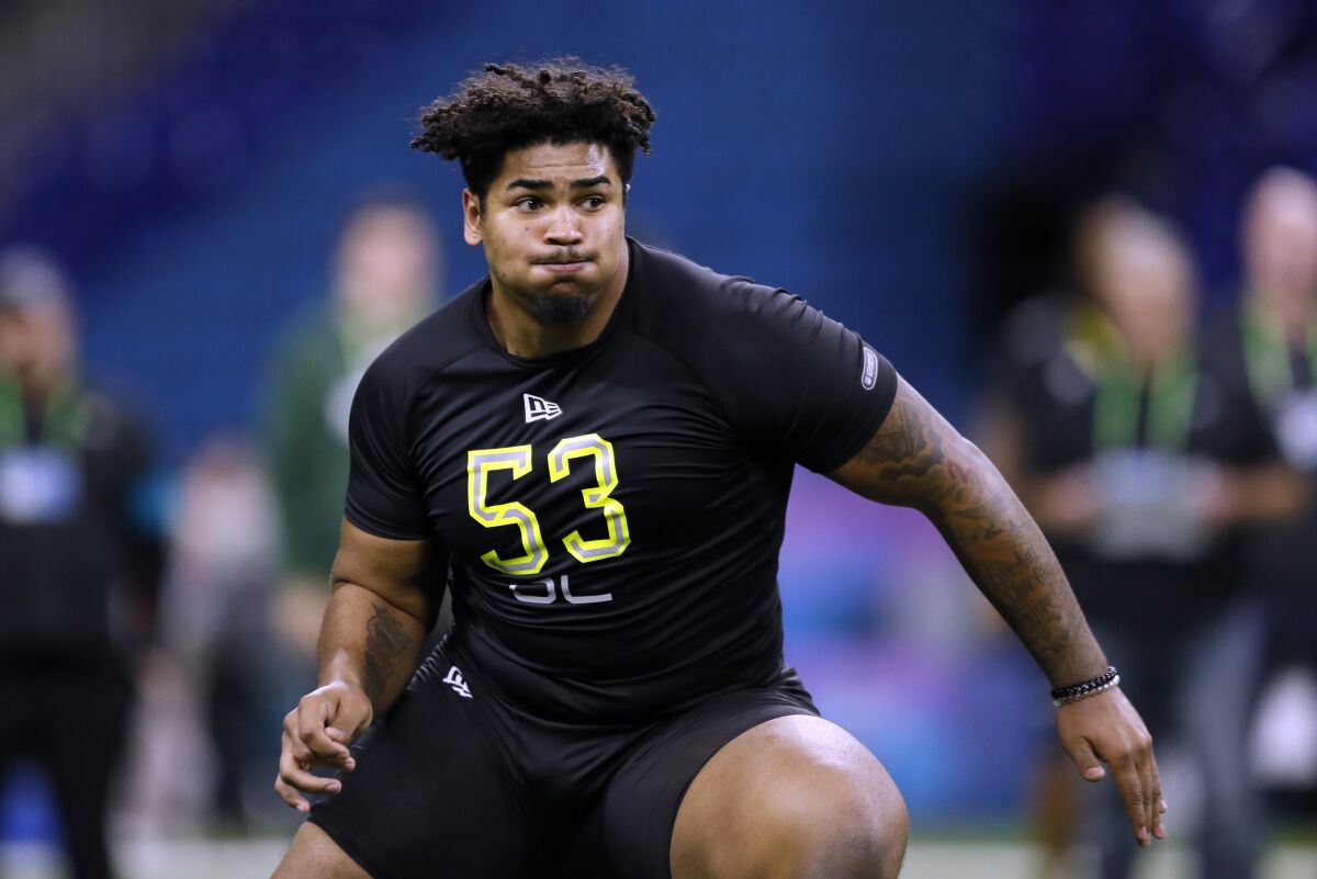 FILE - In this Feb. 28, 2020, file photo, Iowa offensive lineman Tristan Wirfs runs a drill at the NFL football scouting combine in Indianapolis. Wirfs was selected by the Tampa Bay Buccaneers in the first round of the NFL draft. (AP Photo/Charlie Neibergall, File)