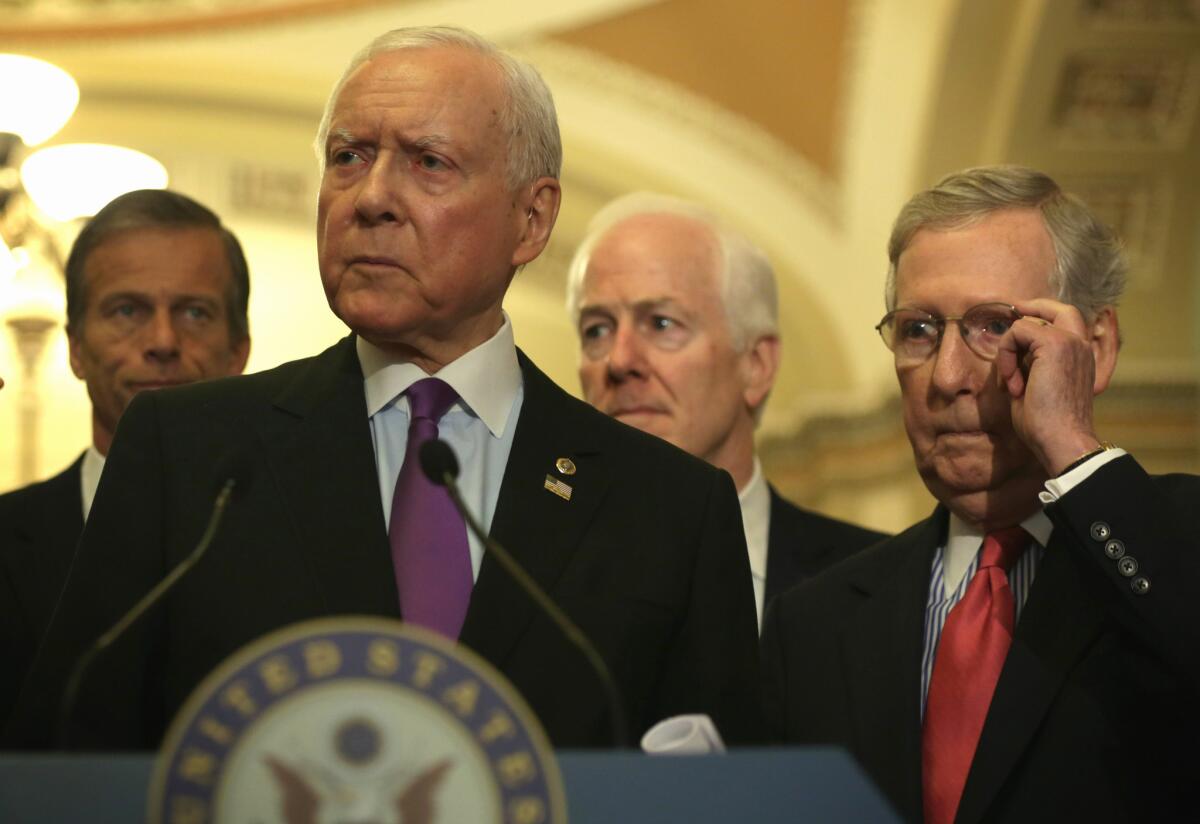 Senate Finance Committee Chairman Orrin Hatch (R-Utah) speaks to reporters as Senate Majority Leader Sen. Mitch McConnell (R-Ky), right, listens after the weekly Senate Republican policy luncheon on May 12.
