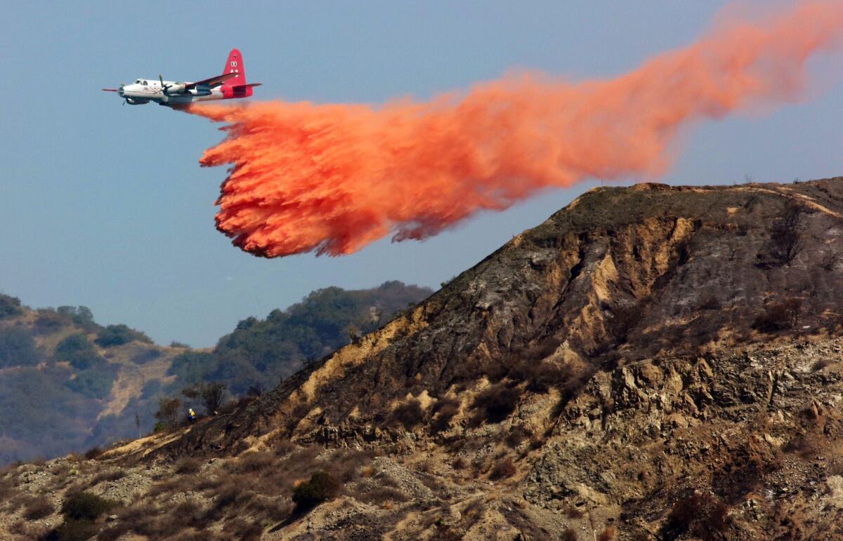 A P-2V drops retardant on the Madre fire in the Angeles National Forest above Azusa.