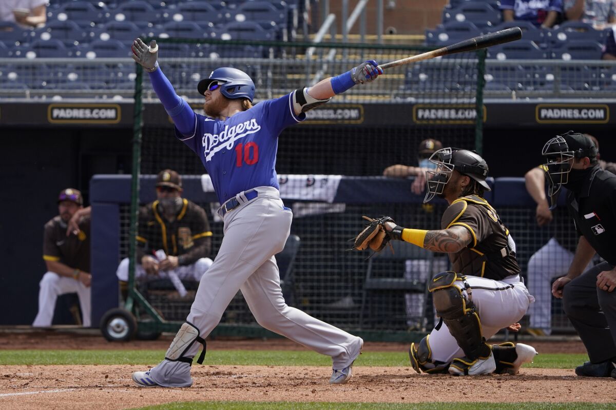 Dodgers third baseman Justin Turner hits a pitch against the San Diego Padres on Saturday.