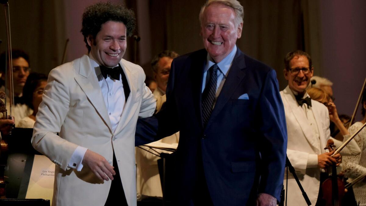 Los Angeles Philharmonic Music Director Gustavo Dudamel and longtime Dodgers sportscaster Vin Scully at the Hollywood Bowl, where Scully served as narrator for Aaron Copland's 1942 work "Lincoln Portrait."
