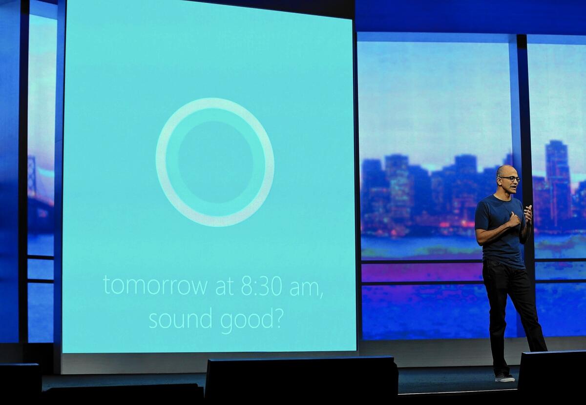 Microsoft Chief Executive Satya Nadella demonstrates Cortana, a digital personal assistant on Windows phones, during a conference in 2014.