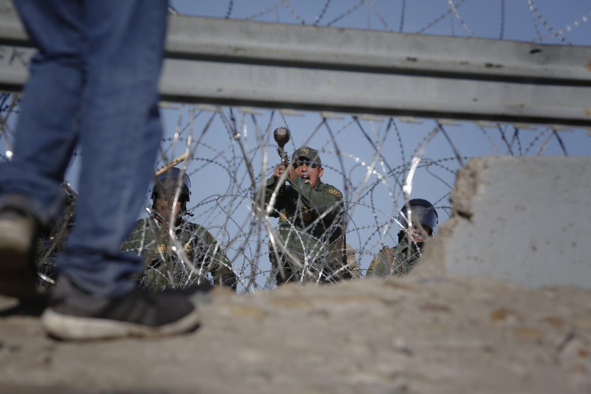 U.S. Border Patrol gives instructions to migrants near the U.S. Mexico border to step away.
