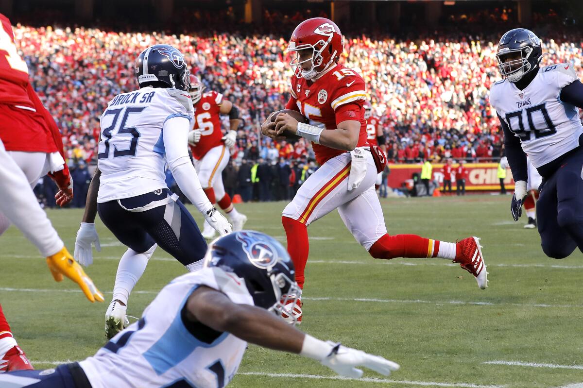 Chiefs quarterback Patrick Mahomes breaks free for a 27-yard touchdown run just before halftime against the Titans on Jan. 19 in the AFC Championship Game at Arrowhead Stadium.