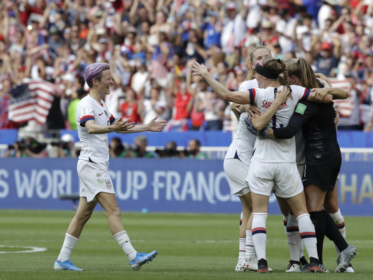 U.S. forward Megan Rapinoe, left, joins teammates in celebration after defeating the Netherlands in the Women's World Cup final on Sunday in Lyon, France.