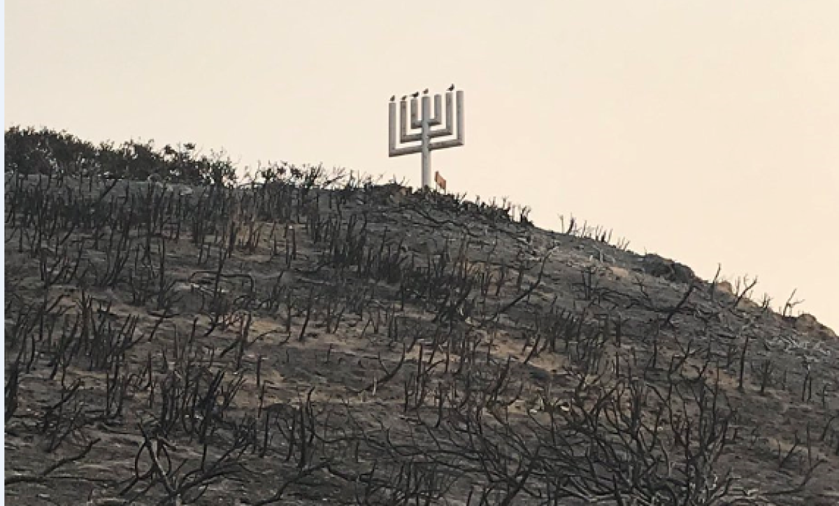 Camp Kramer's wooden Menorah and plaque honoring founder Rabbi Alfred Wolf were still standing after the camp burned in the Woolsey fire.