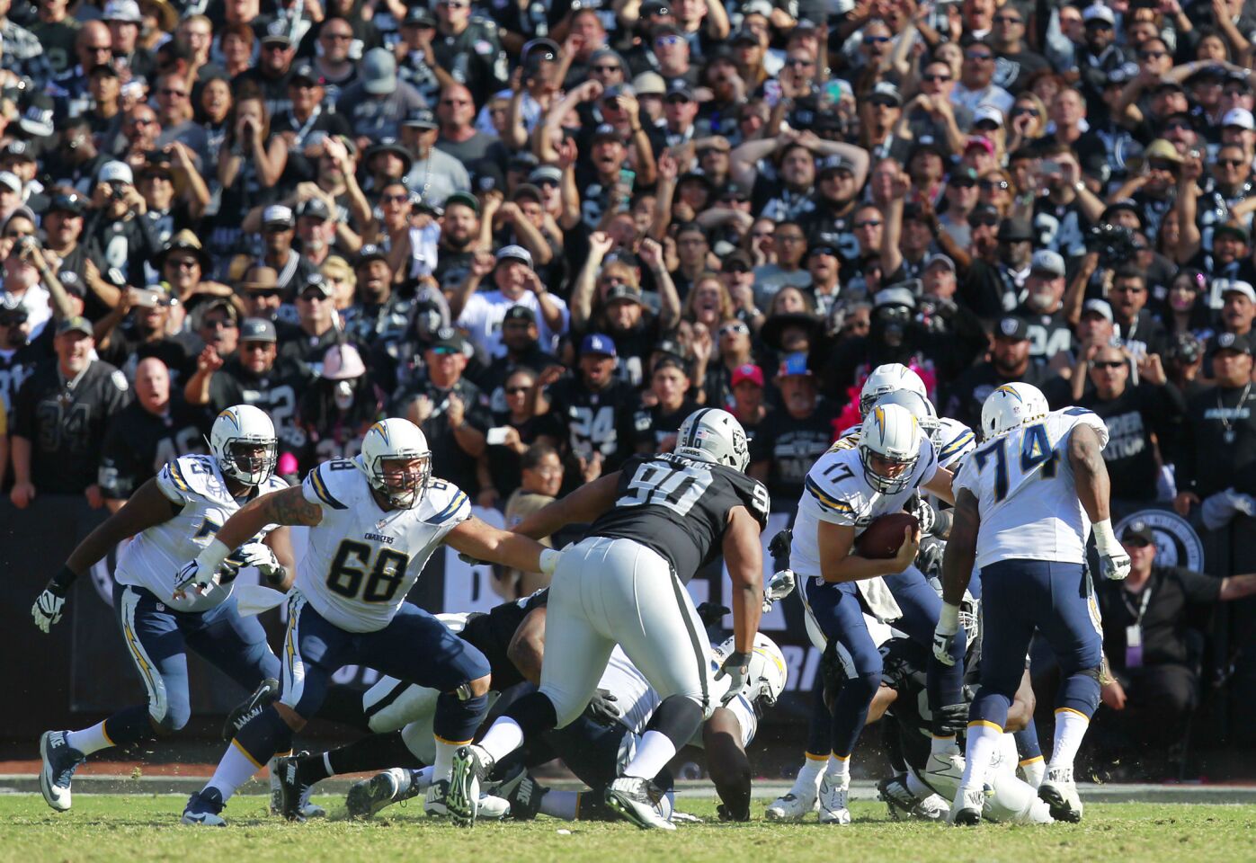 San Diego Chargers Philip Rivers is sacked by Raiders Stacy McGee in the 3rd quarter in Oakland on Oct. 9, 2016. (Photo by K.C. Alfred/The San Diego Union-Tribune)